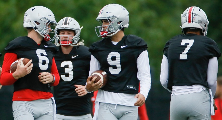 Kyle McCord (6), Quinn Ewers (3), Jack Miller III (9) and C.J. Stroud (7) warm up during football training camp at the Woody Hayes Athletic Center in Columbus on Wednesday, Aug. 18, 2021.